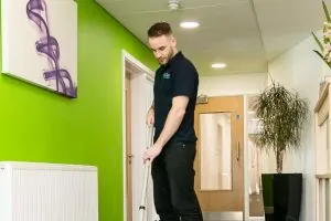 Professional Office Cleaning service vacuuming office hallway with professional equipment