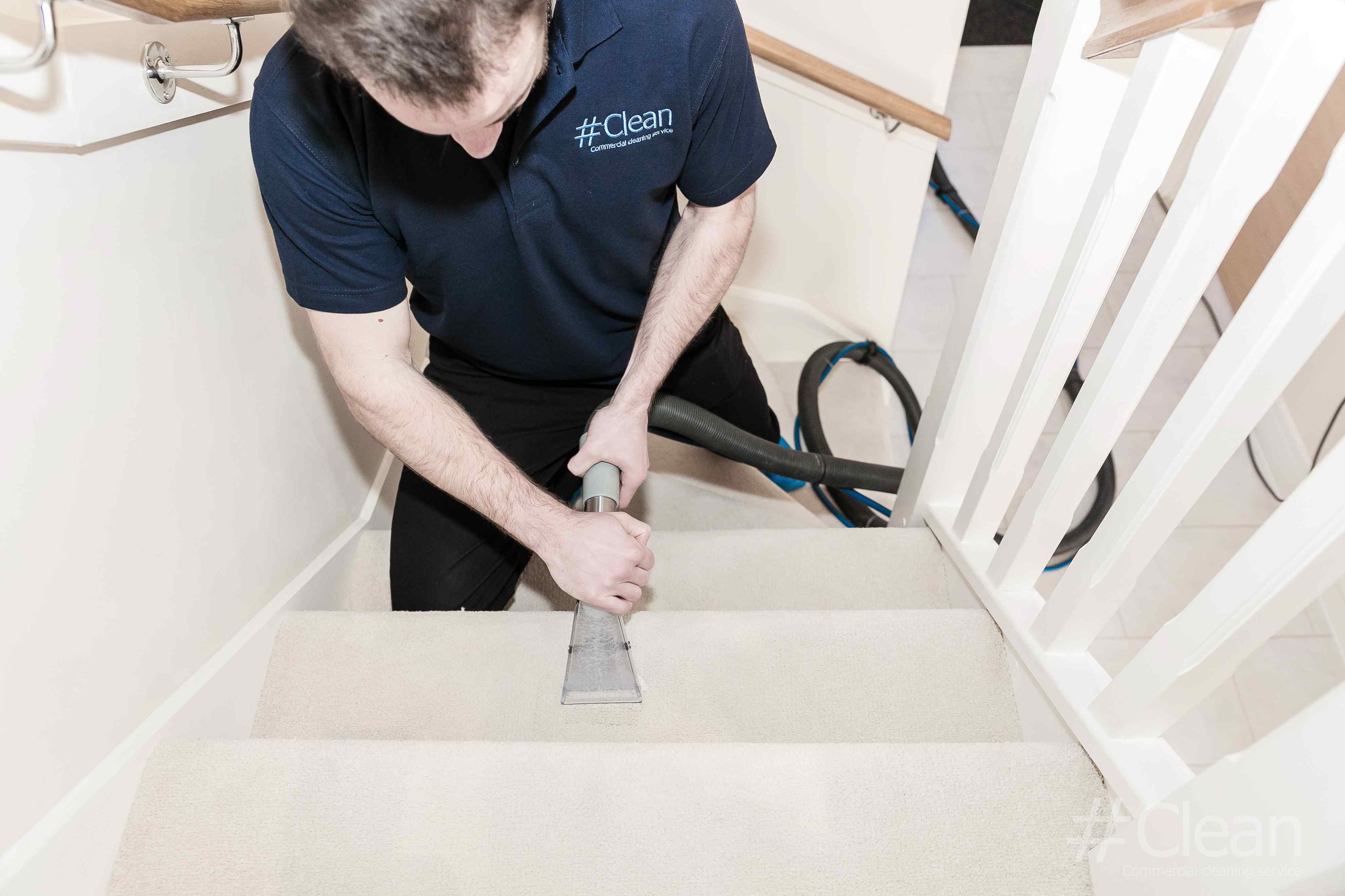 Man Using A Carpet Cleaner On Stairs