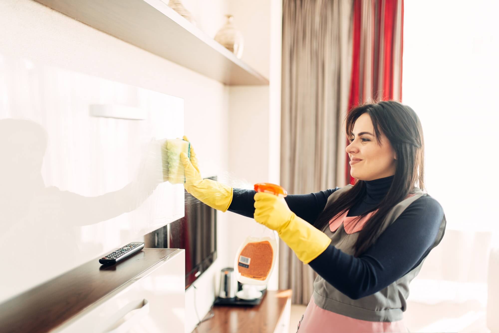 Housemaid Cleans Furniture With A Cleaning Spray
