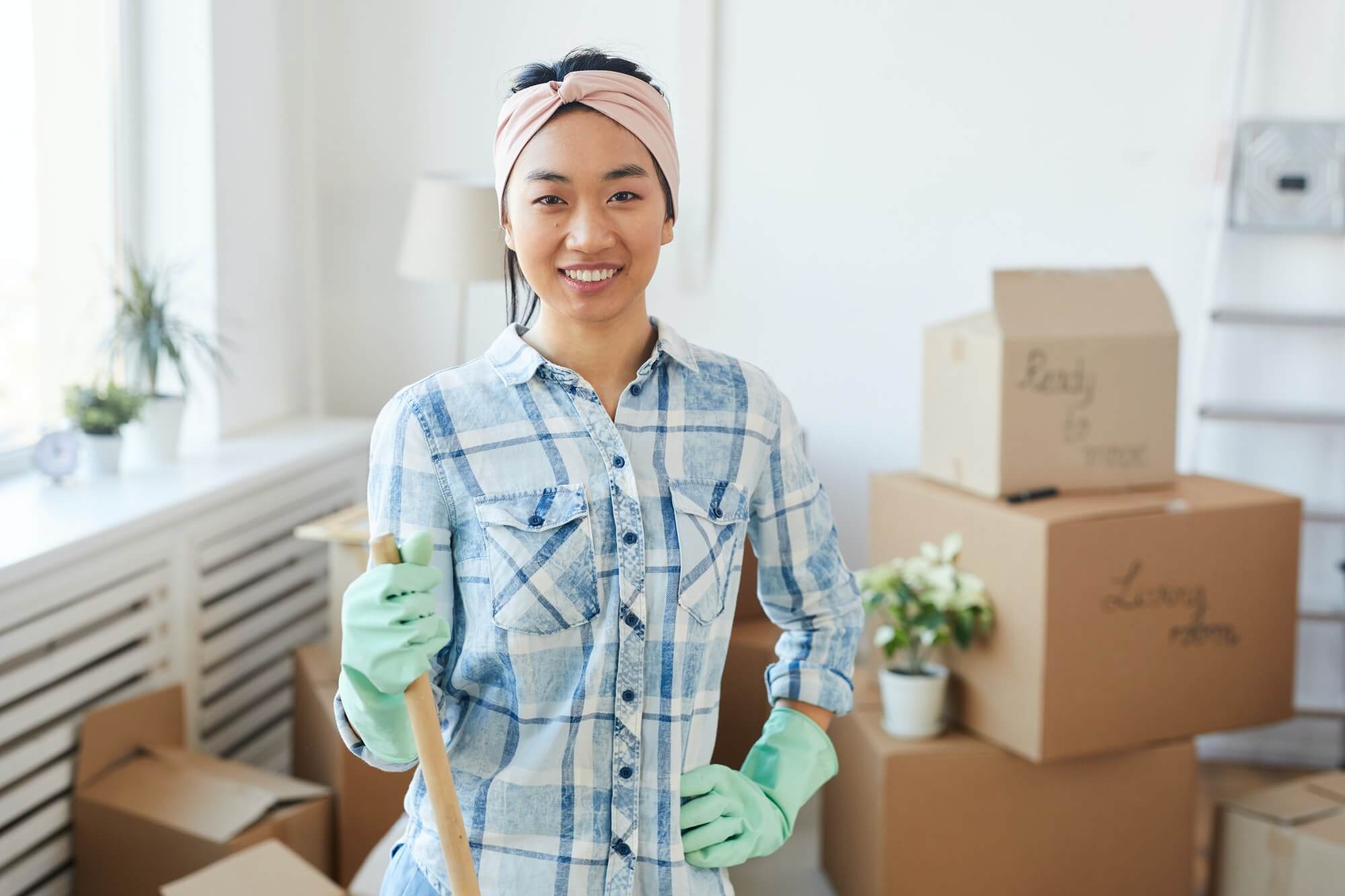 Young Asian Woman Posing With Cleaning Tools In New House