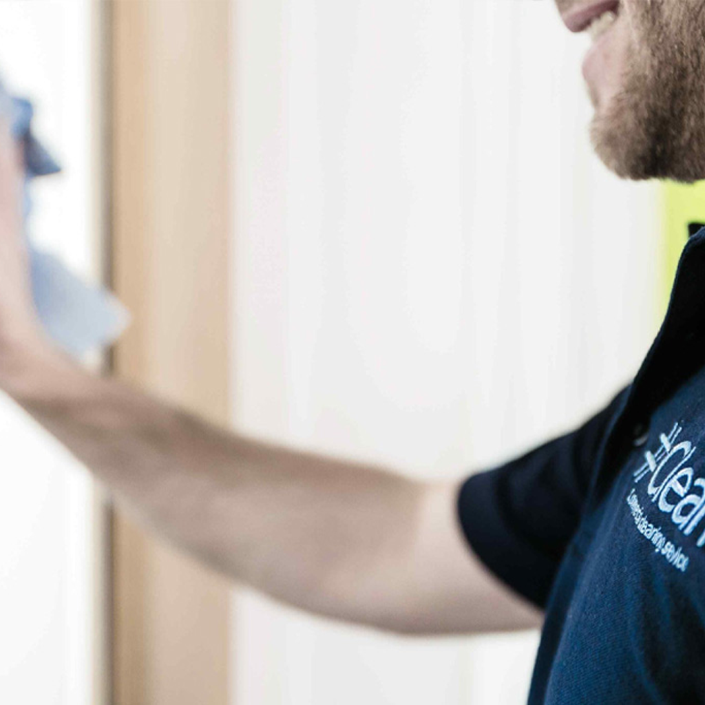 Cleaner wiping window as part of Horsham end of tenancy cleaning service