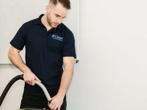 Cleaner carrying out professional office cleaning with specialist equipment