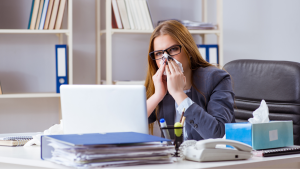 Office worker affected by poor hygiene in shared workspace