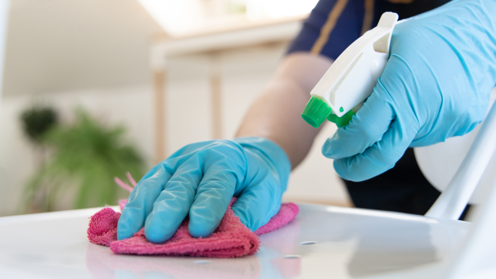 Cleaning a surface with diluted bleach solution using gloves and cloth