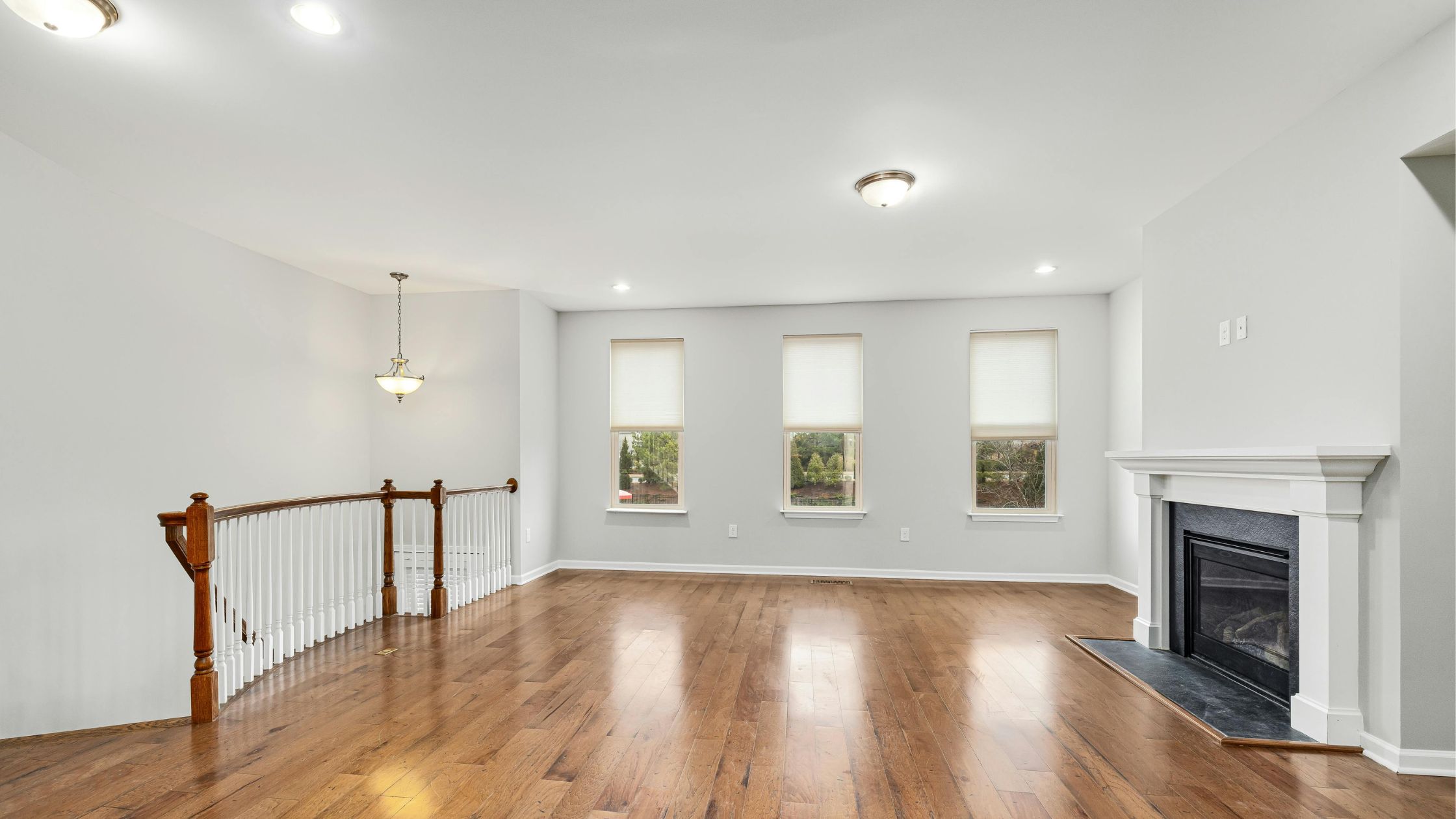 A clear trigger spray bottle and blue cleaning sponge on a grey surface in front of a textured plaster wall, representing professional builders clean equipment.